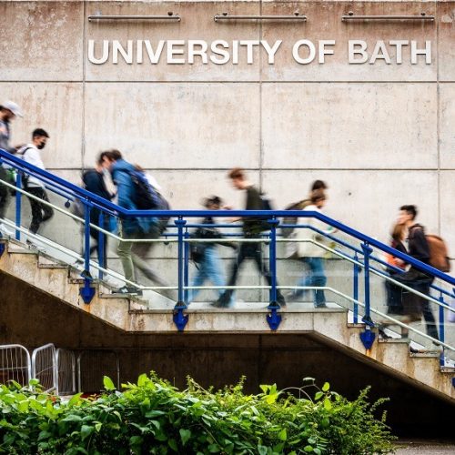 30266 Campus Shots 7 Oct 2021.  Students walking past University Sign and SU Building. Shots with slow shutter causing motion blur Client: Louise Scattergood - CS
